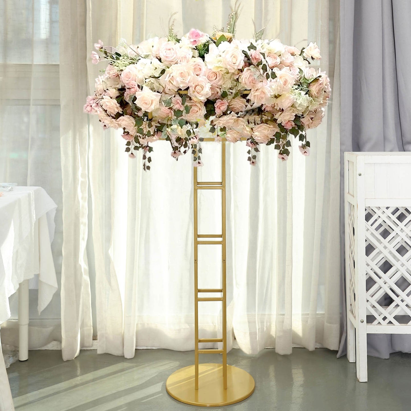 Tall gold floral riser centerpiece with a grand halo of pink flowers.
