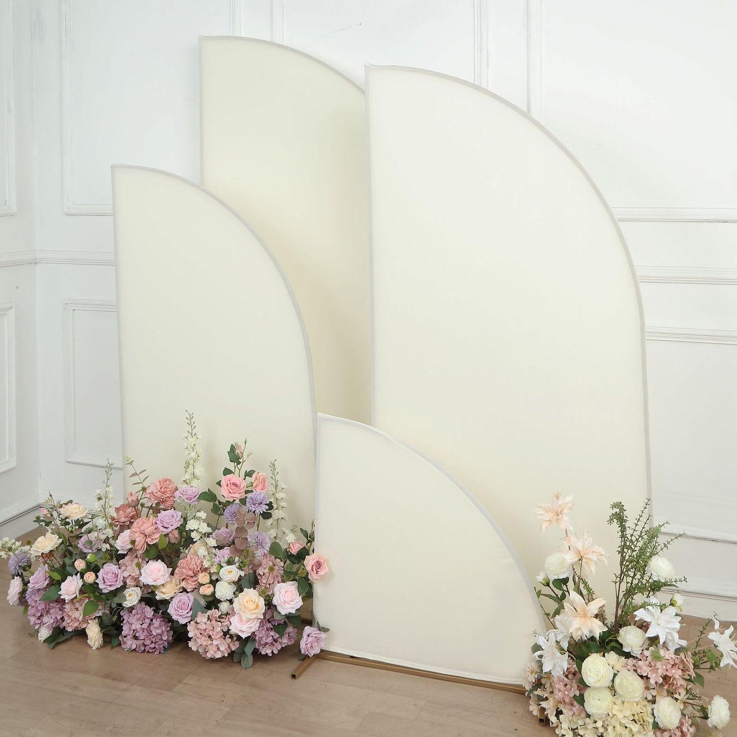 Matte ivory half moon backdrop stand covers with floral arrangements.