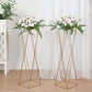 Gold geometric crisscross metal frame flower stands with floral arrangements.