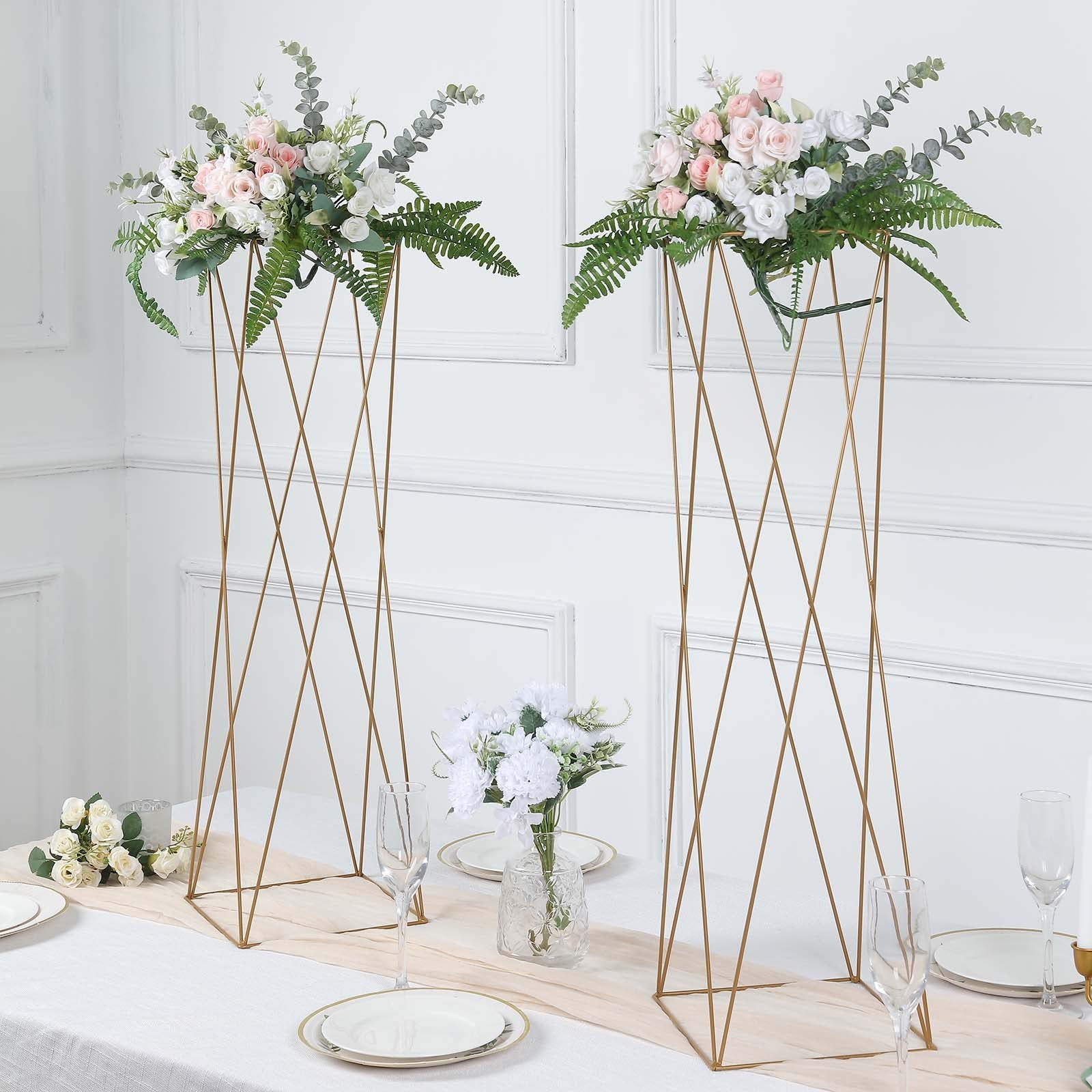 32" Gold Geometric Crisscross Metal Frame Centerpieces with floral arrangements.