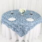 Dusty blue 3D rosette satin table overlay on round table with floral centerpiece.