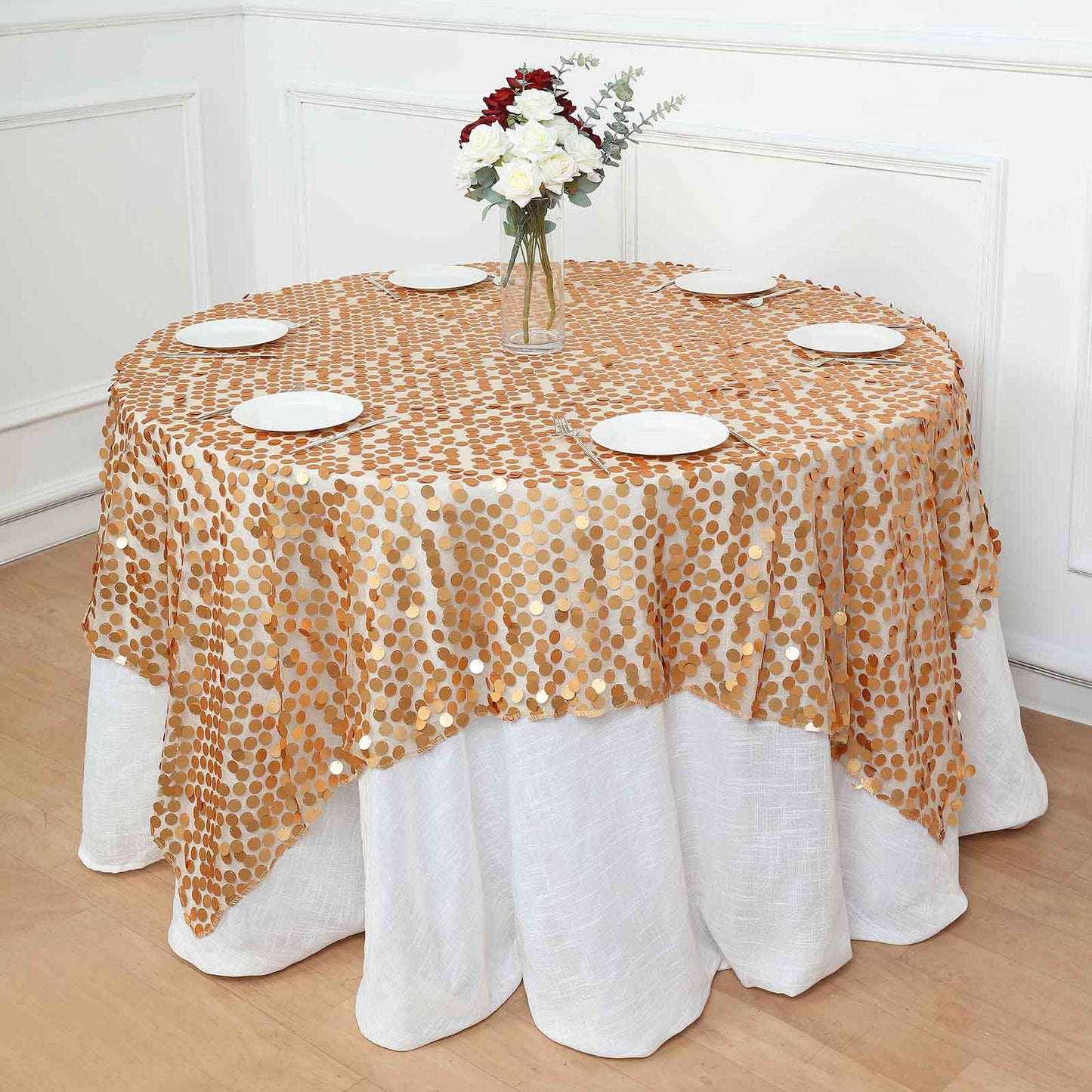 Matte champagne big payette sequin table overlay on a round table.