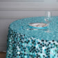 Turquoise sequin table overlay on a round table setting.