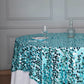 Turquoise sequin table overlay on a round table setting.