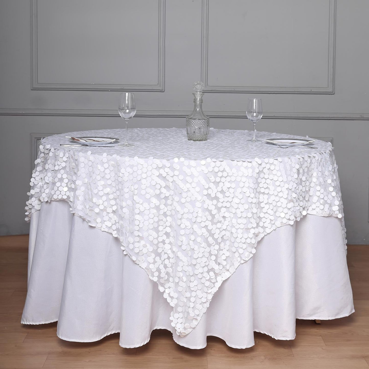 White sequin square table overlay for elegant dining decor.