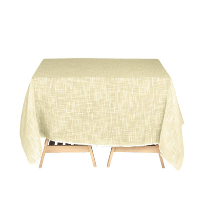 Ivory textured linen square table overlay on a wooden table.