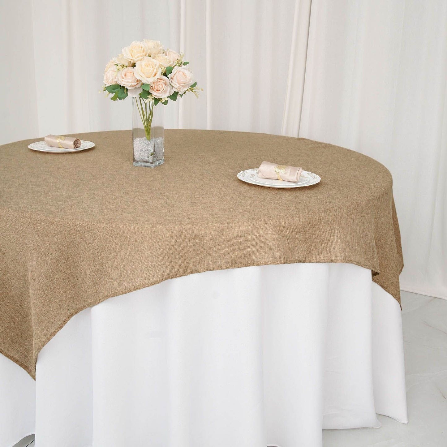 Natural faux jute burlap square table overlay on a round table.