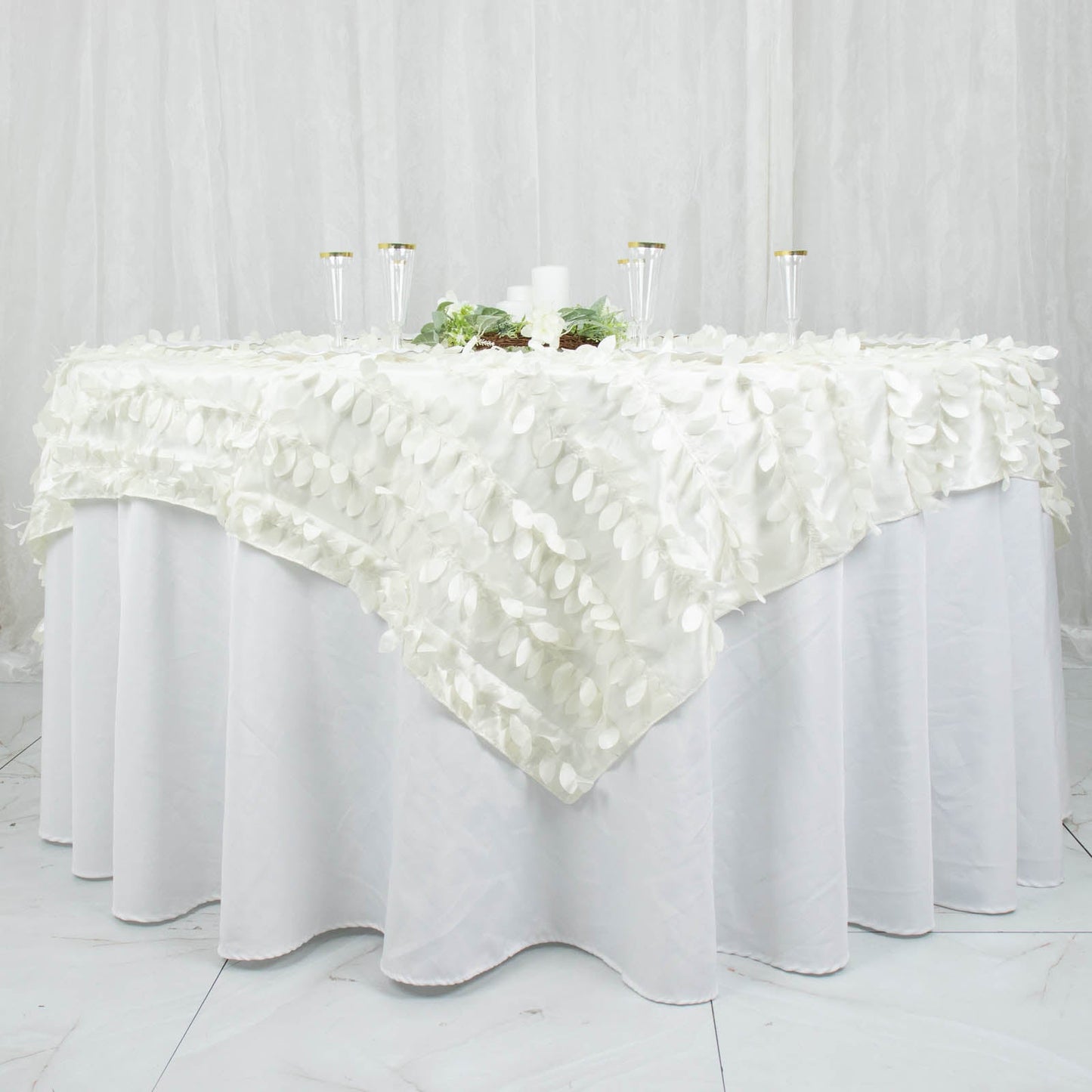 Ivory 3D leaf petal taffeta fabric table overlay on a round table.