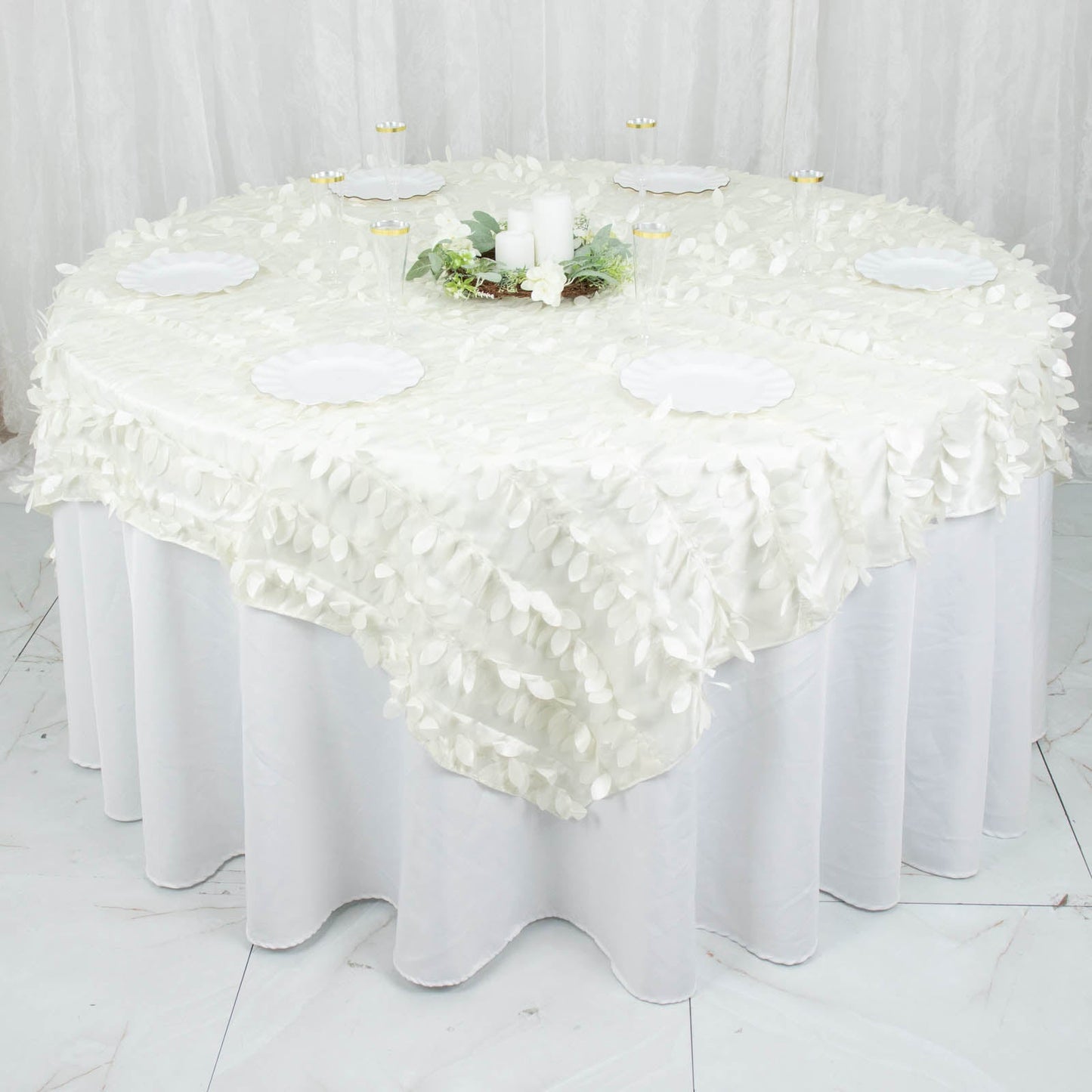 Ivory 3D leaf petal taffeta fabric table overlay on a round table.