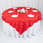 Red 3D leaf petal taffeta fabric table overlay on a round table.
