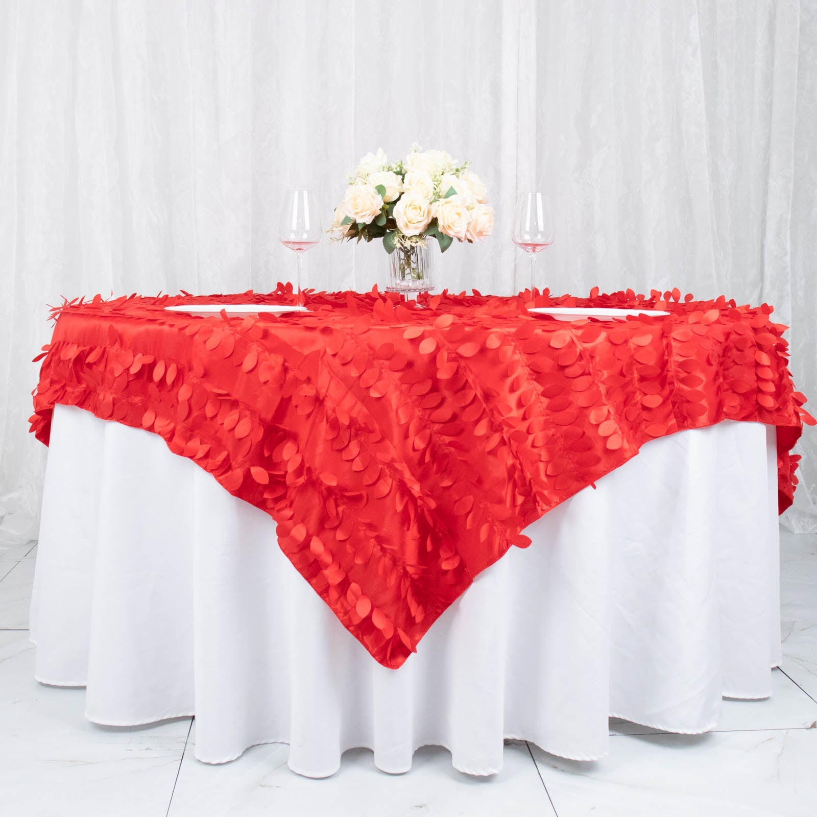 Red 3D leaf petal taffeta fabric table overlay on a round table.