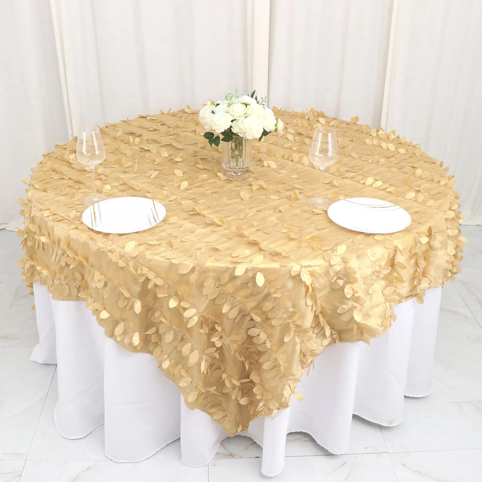 Champagne leaf petal taffeta table overlay on a round table.