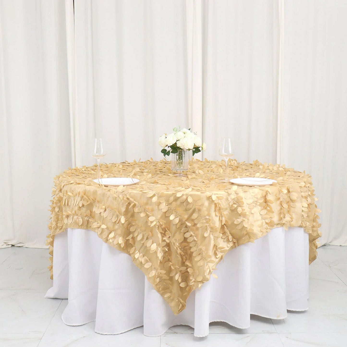 Champagne leaf petal taffeta table overlay on a round table.