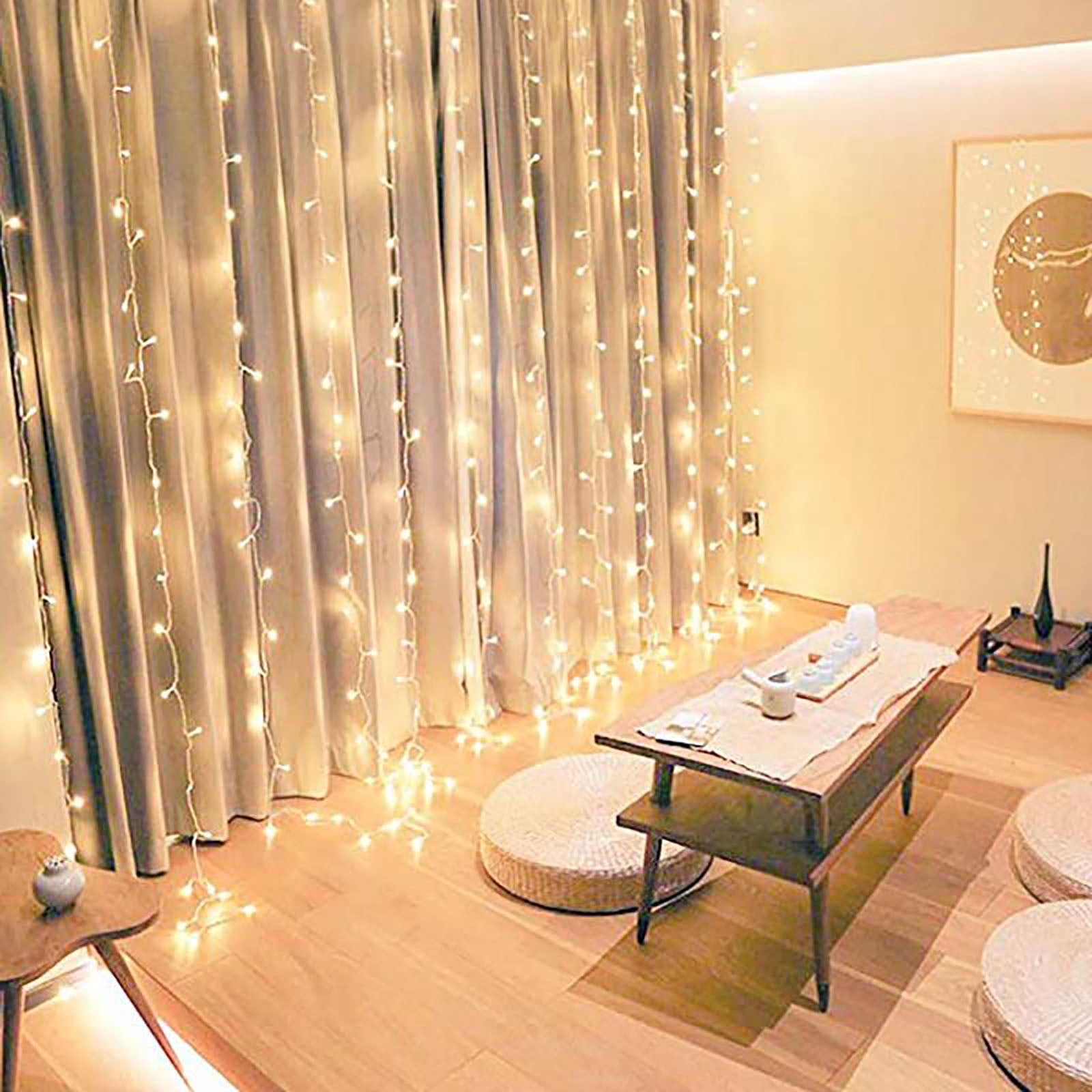 Warm white 300 LED icicle curtain fairy string lights in a cozy setting.
