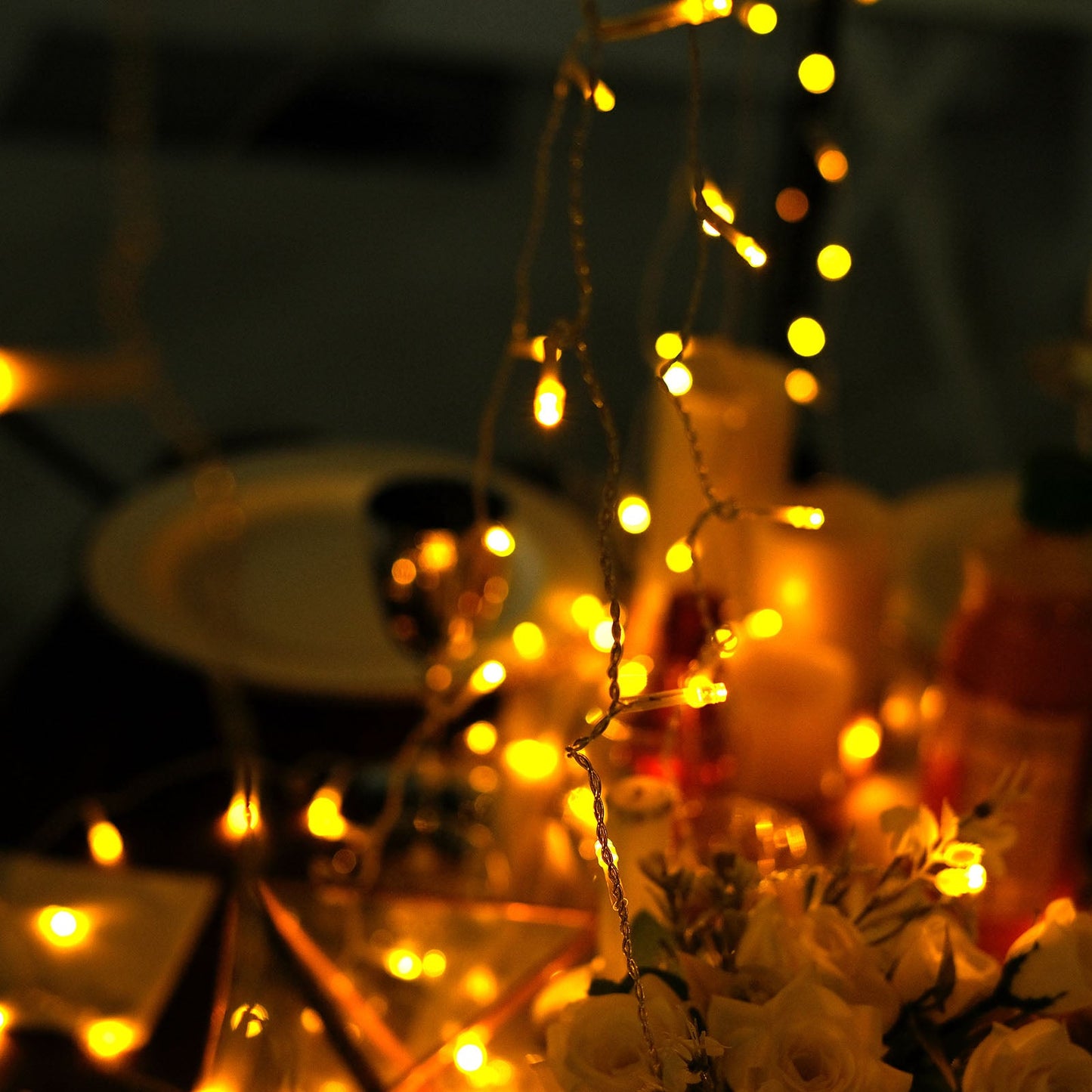 Warm white 192 LED icicle curtain fairy string lights in a cozy setting.