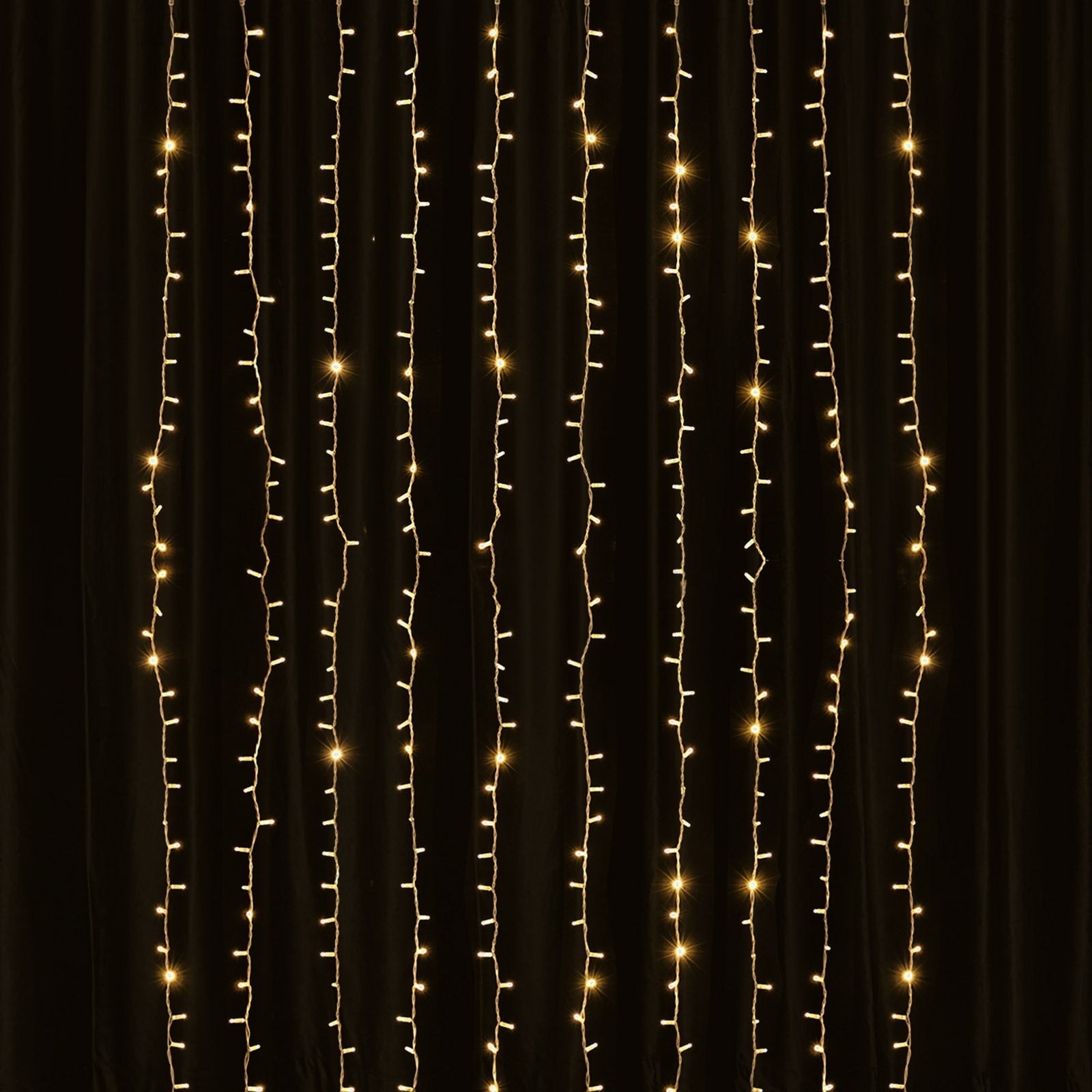 Warm white 192 LED icicle curtain string lights in a dark setting.