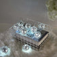 Silver disco mirror ball string lights with cool white LEDs in a decorative basket.