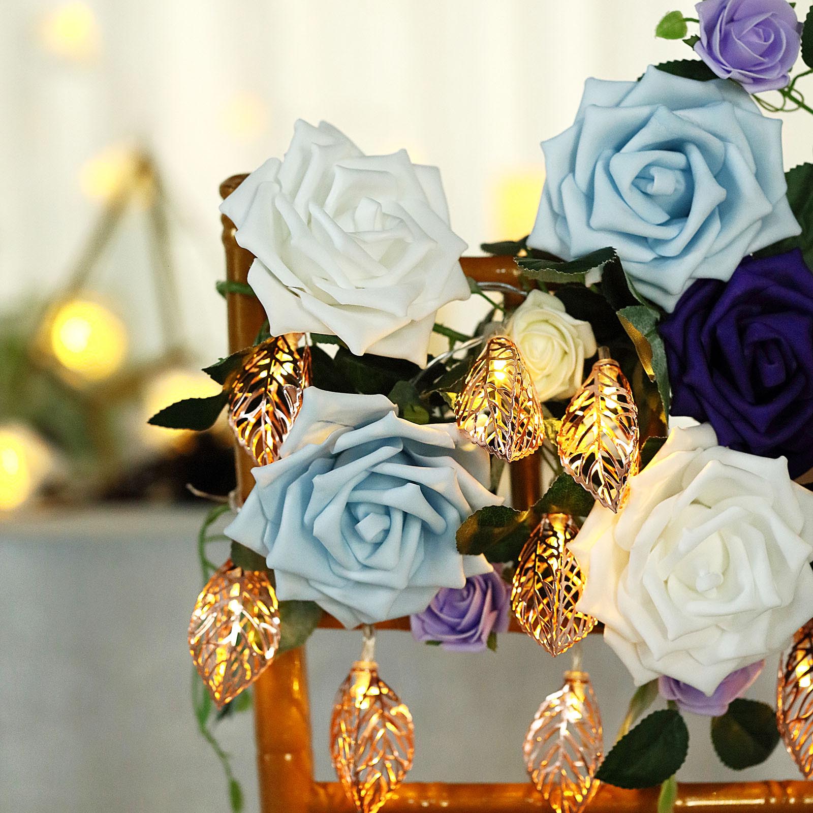 Rose gold leaves fairy lights with warm white glow and decorative roses.