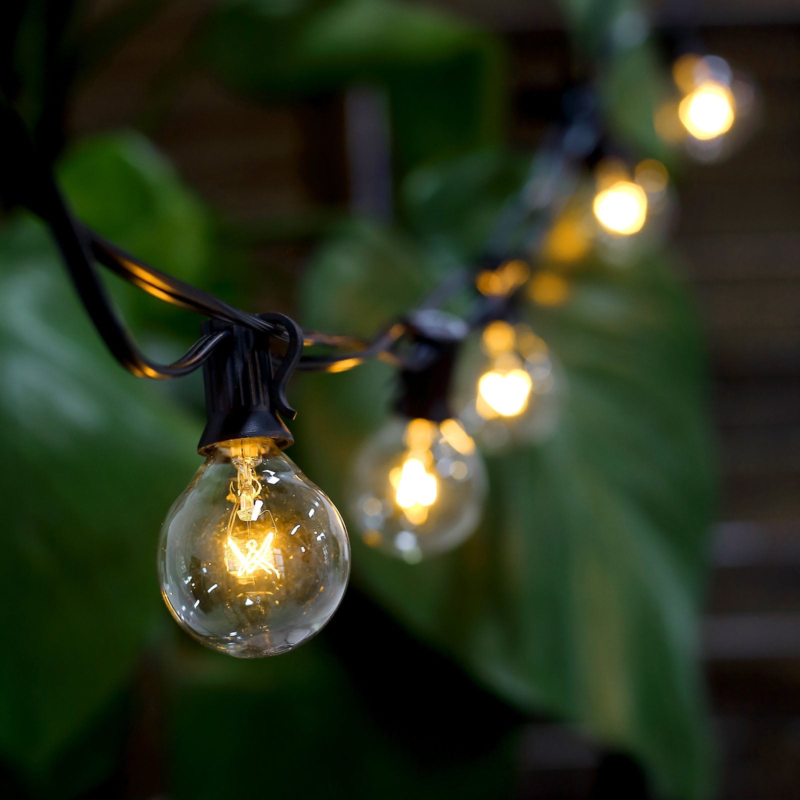 Warm white connectable hanging string lights with glass bulbs.