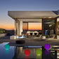 Colorful inflatable garden light up balls by the pool at sunset.