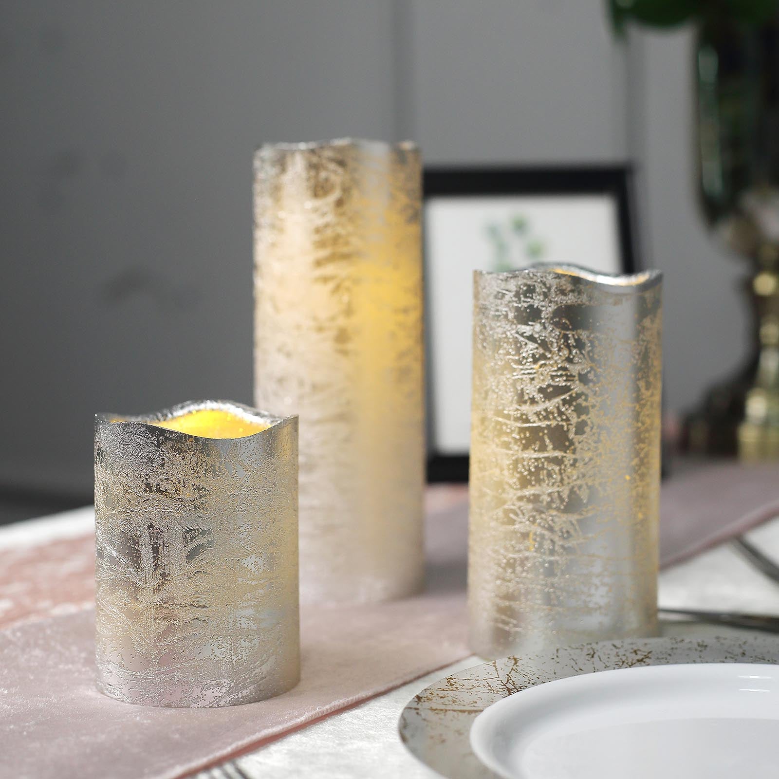 Metallic silver LED pillar candles, flameless and remote operated.
