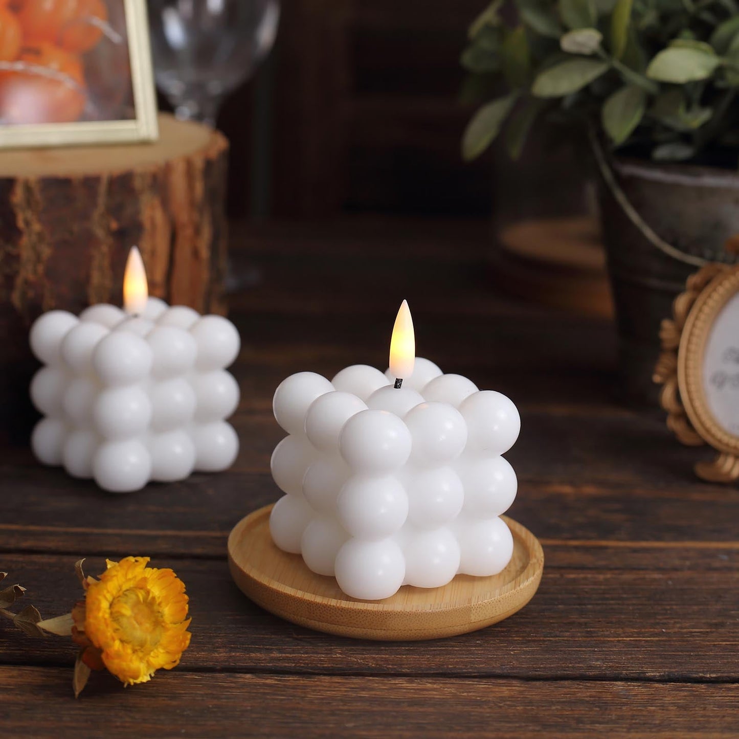 White LED bubble candles on a wooden tray.