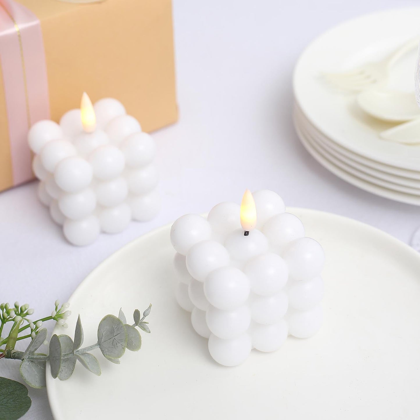 White LED bubble candles flickering on a table setting.