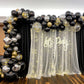 Neon "Let's Party" sign with black and gold balloon decor.