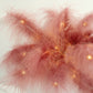 Cinnamon rose feather table lamp with warm LED lights for wedding centerpiece.