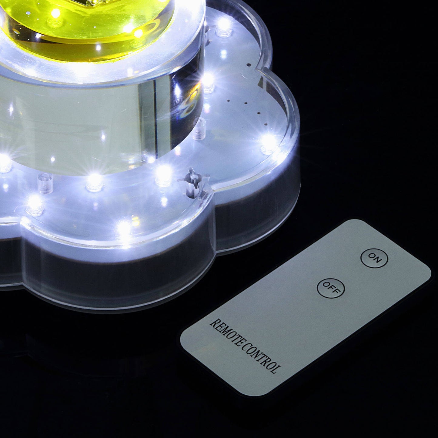 White flower-shaped LED disc lights with remote control.