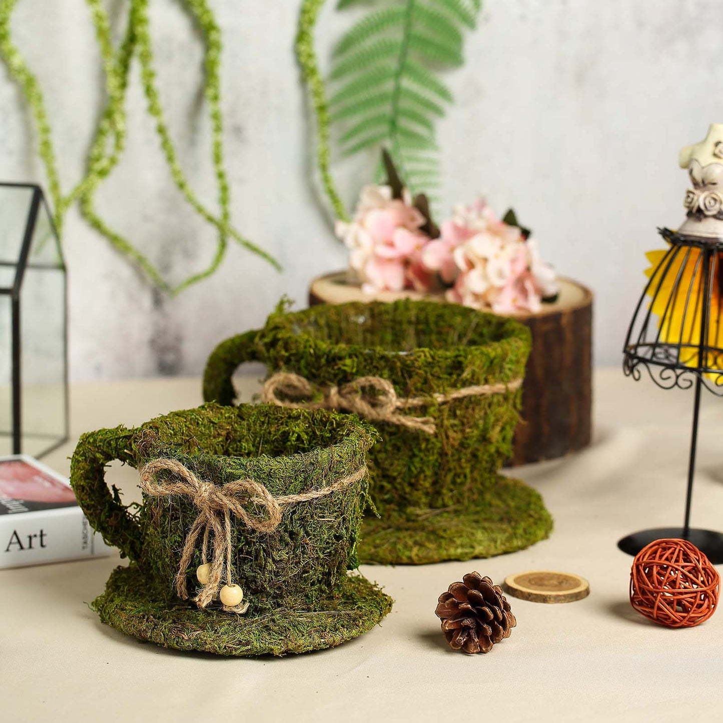 Green teacup planters with preserved moss and twine, perfect for floral displays.