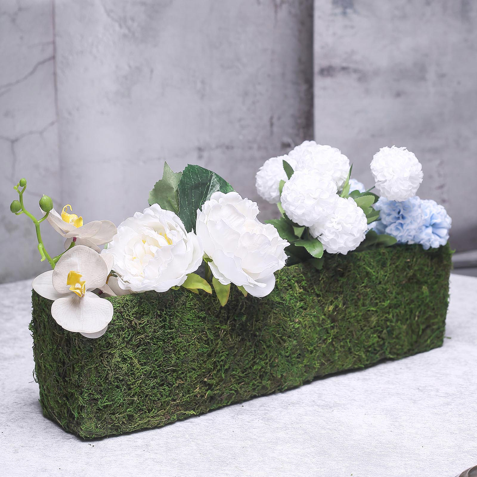Green rectangle preserved moss metal planter box with flowers.