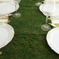 14"x48" green natural preserved moss table runner with fishnet grid on a dining table.