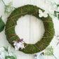 14" green natural preserved moss wreath with twine wrap and decorative butterflies.