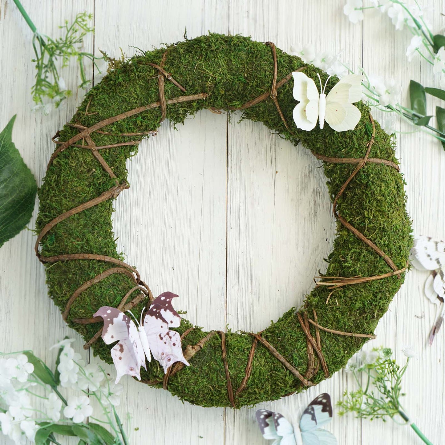 14" green natural preserved moss wreath with twine wrap and decorative butterflies.