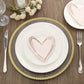 Rose gold heart-shaped disposable cocktail napkins on a plate.