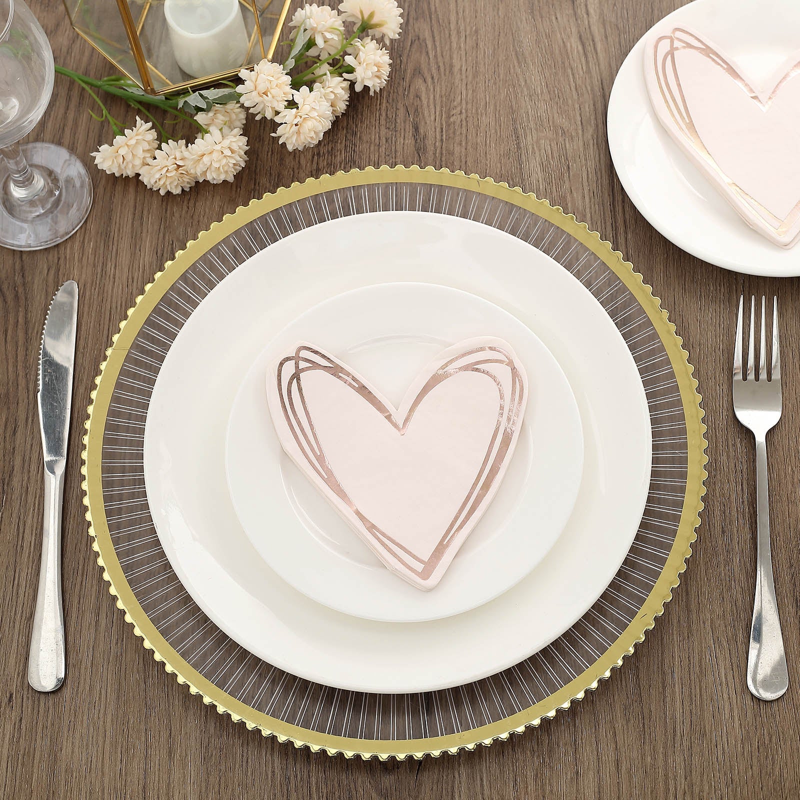 Rose gold heart-shaped disposable cocktail napkins on a plate.