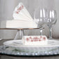 White linen-feel napkins with rose gold floral print on a dining table.