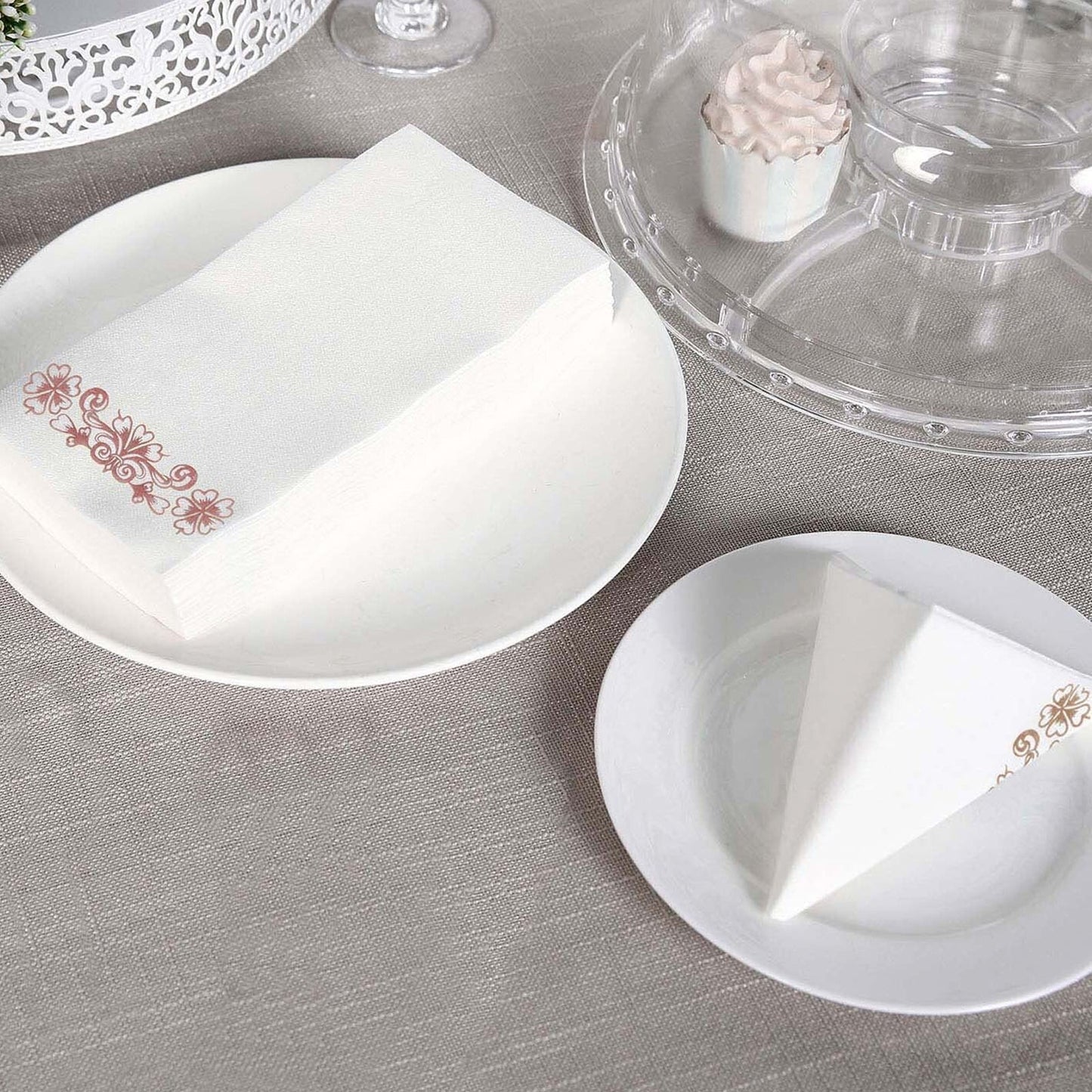 White linen-feel paper napkins with rose gold floral print.