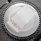 White linen-feel napkin with rose gold floral print on elegant table setting.