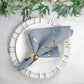 Modern dusty blue and geometric gold cloth dinner napkin on a plate.