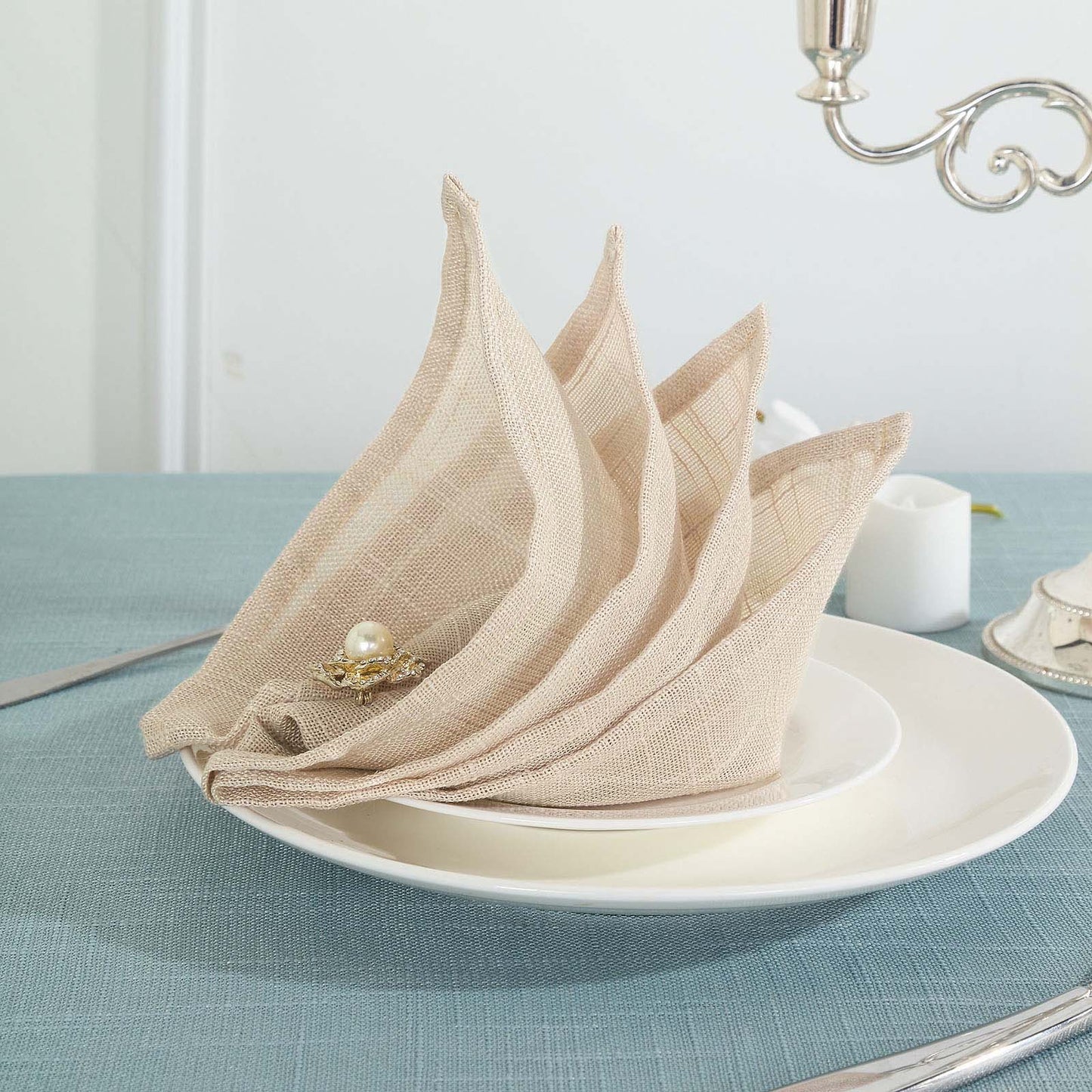 Beige slubby textured cloth dinner napkins in a stylish setting.