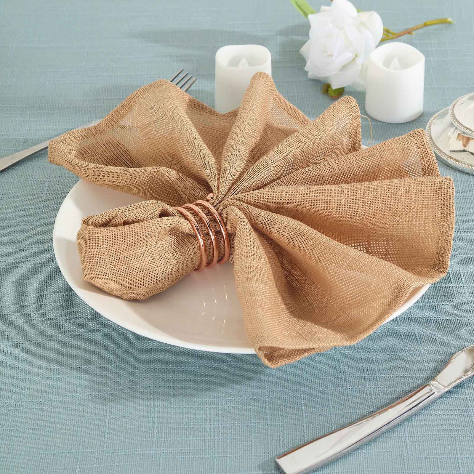 Natural slubby textured cloth dinner napkins in light brown.
