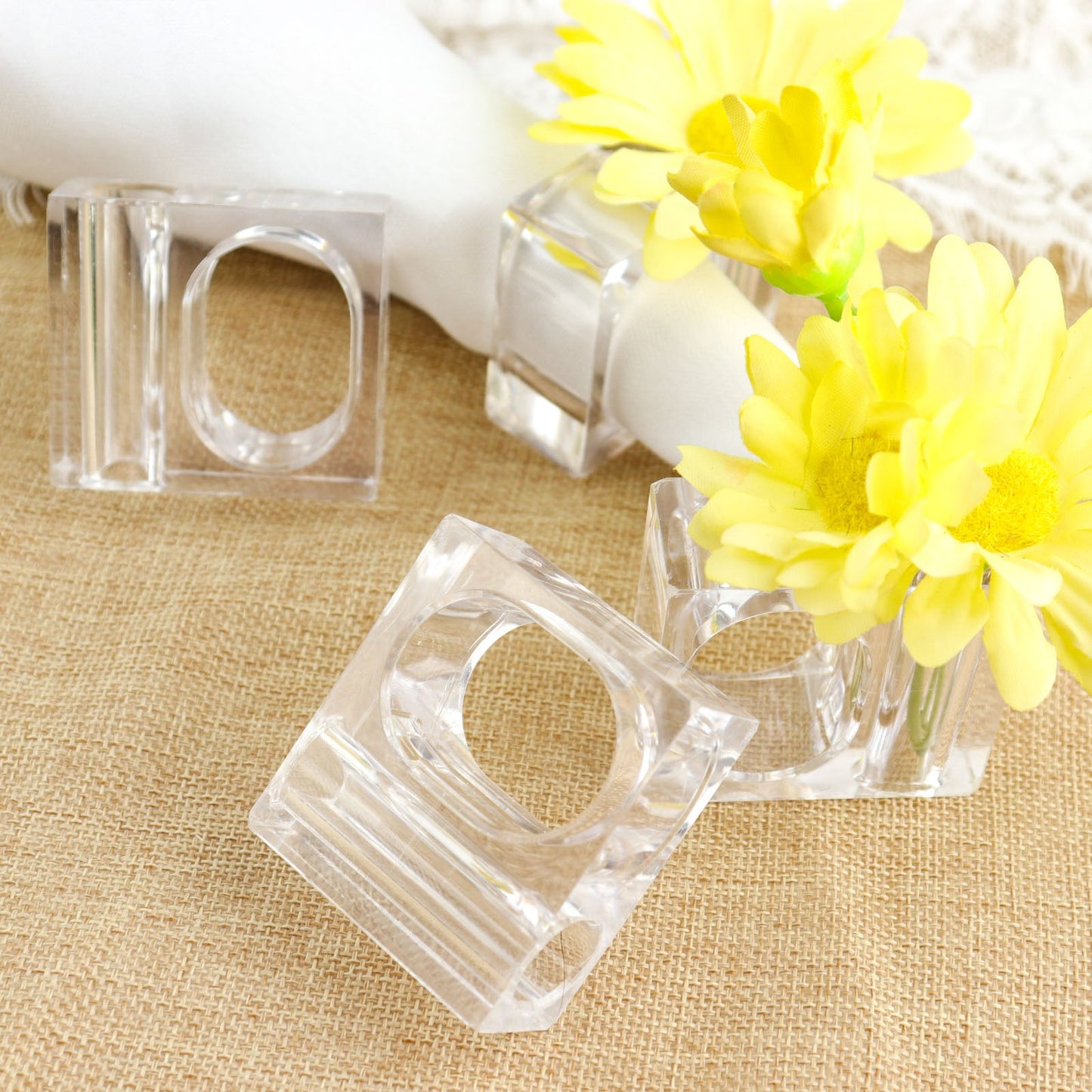 Clear acrylic square mini bud vase napkin rings with yellow flowers.