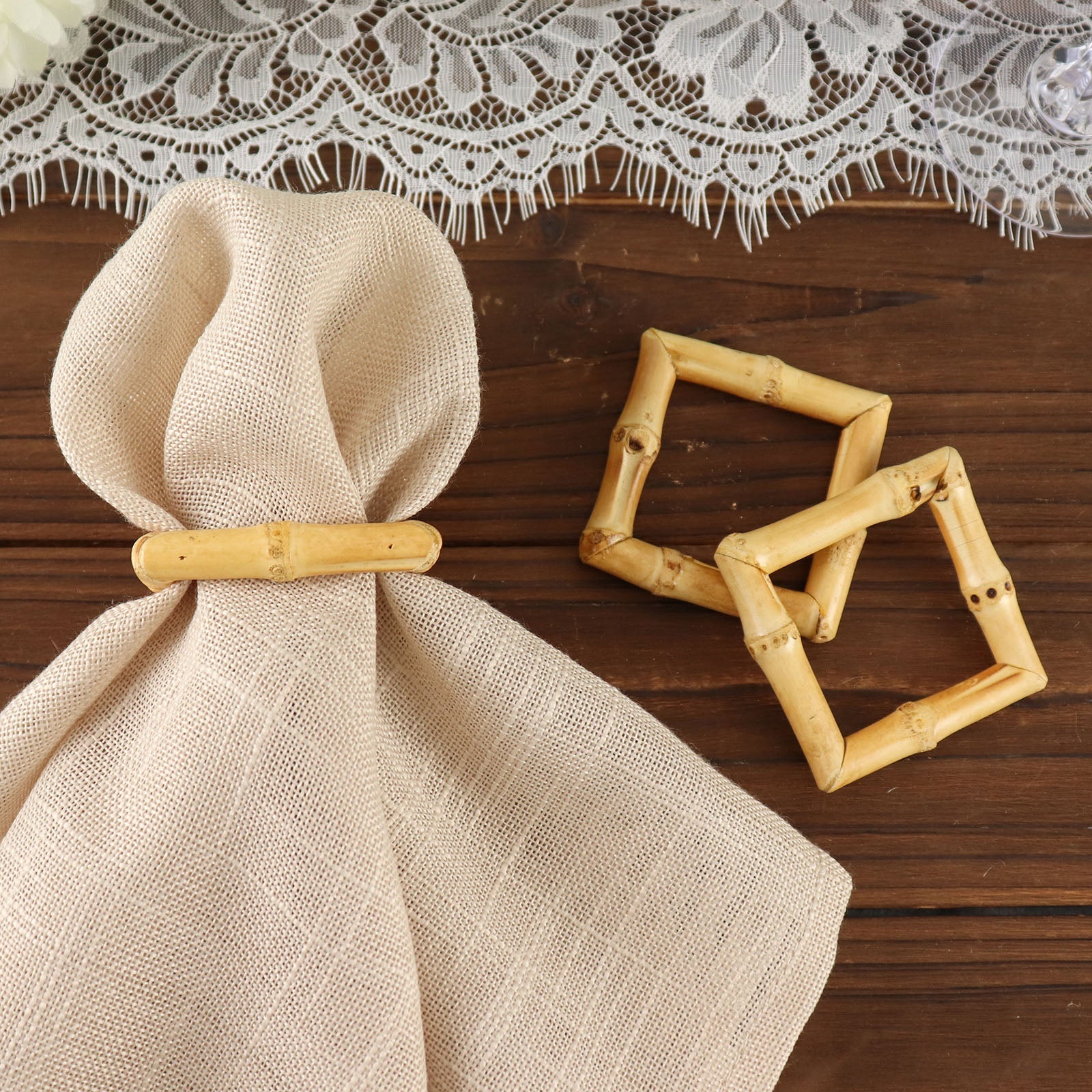 Natural bamboo square napkin rings on a rustic wooden table.