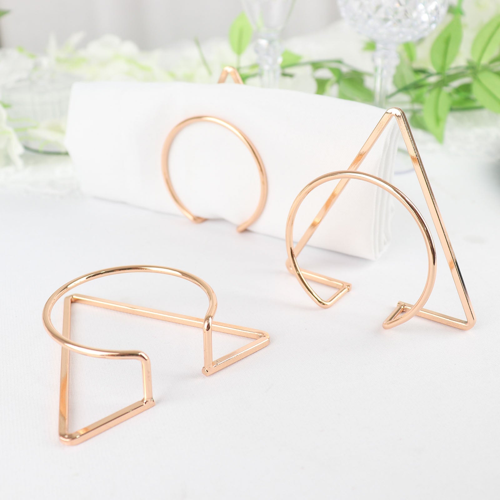 Gold geometric metal napkin rings in modern Nordic style.