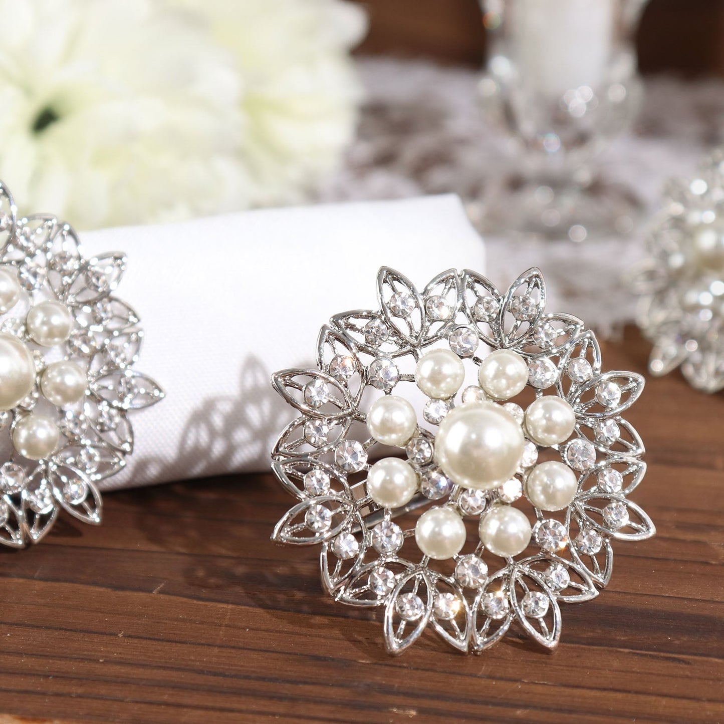 Silver pearl and diamond rhinestone flower napkin rings.