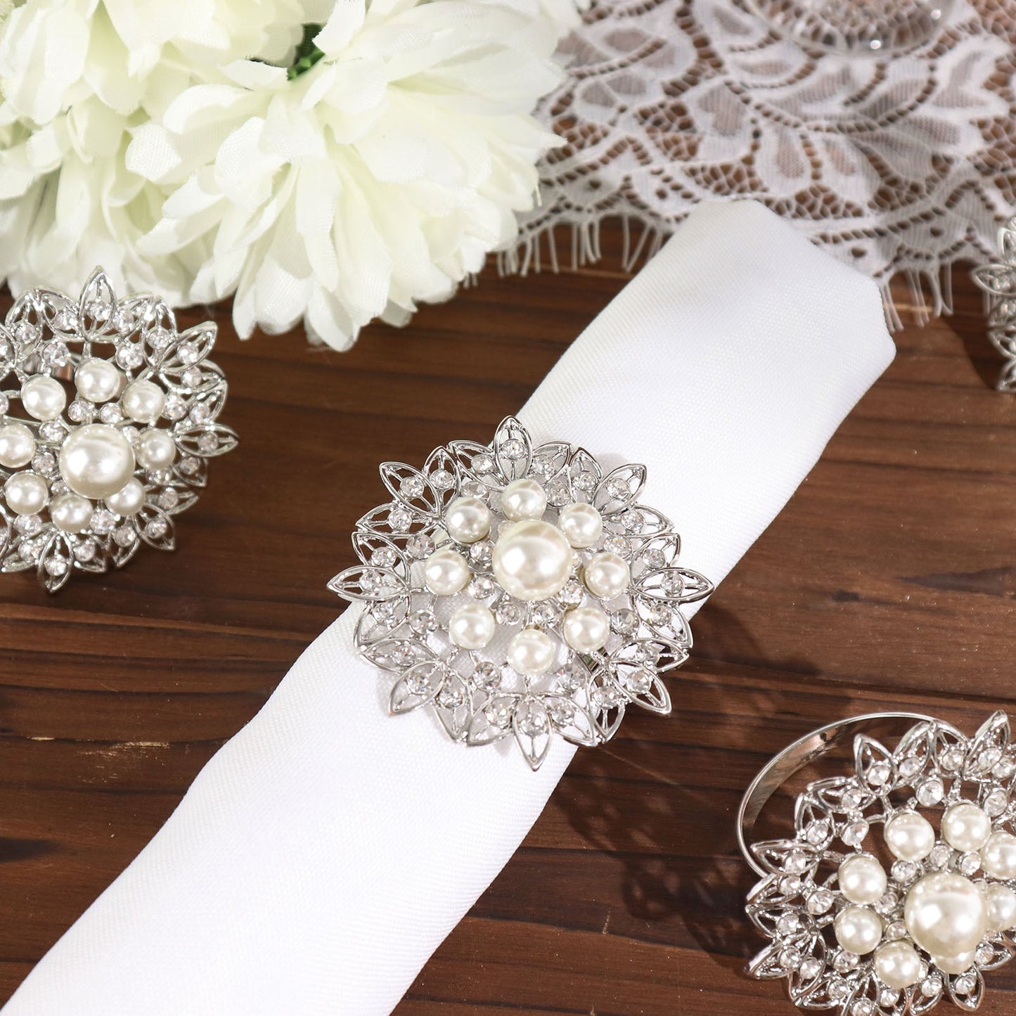 Silver pearl and diamond rhinestone flower napkin rings.