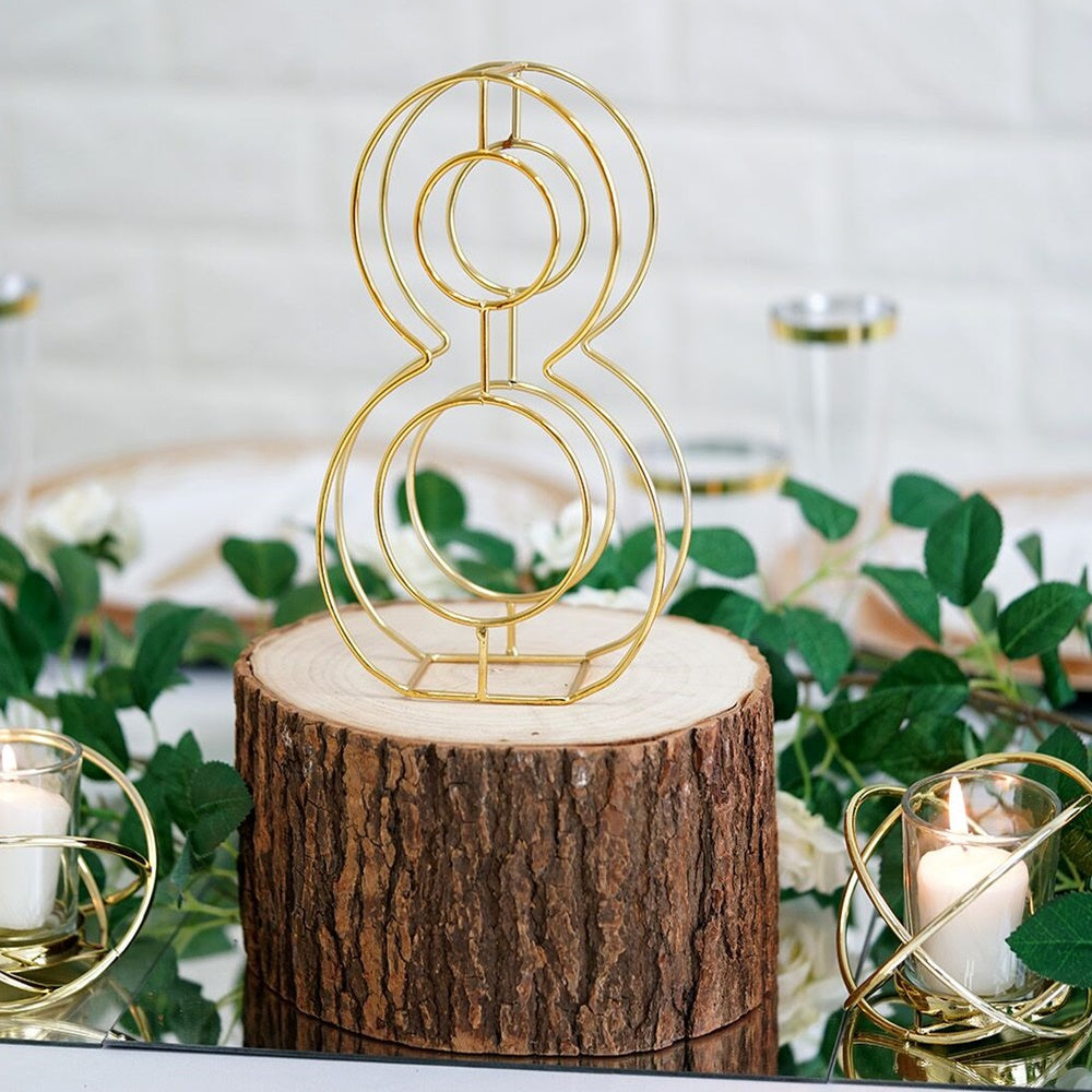 Gold 3D decorative wedding table number "8" on a wooden base.