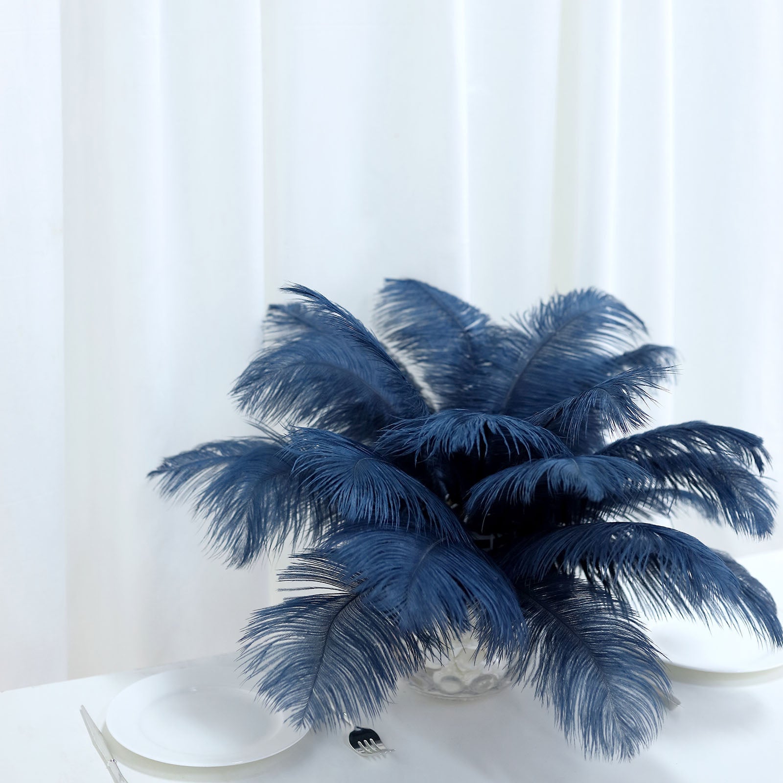 Navy blue natural plume real ostrich feathers in a decorative arrangement.